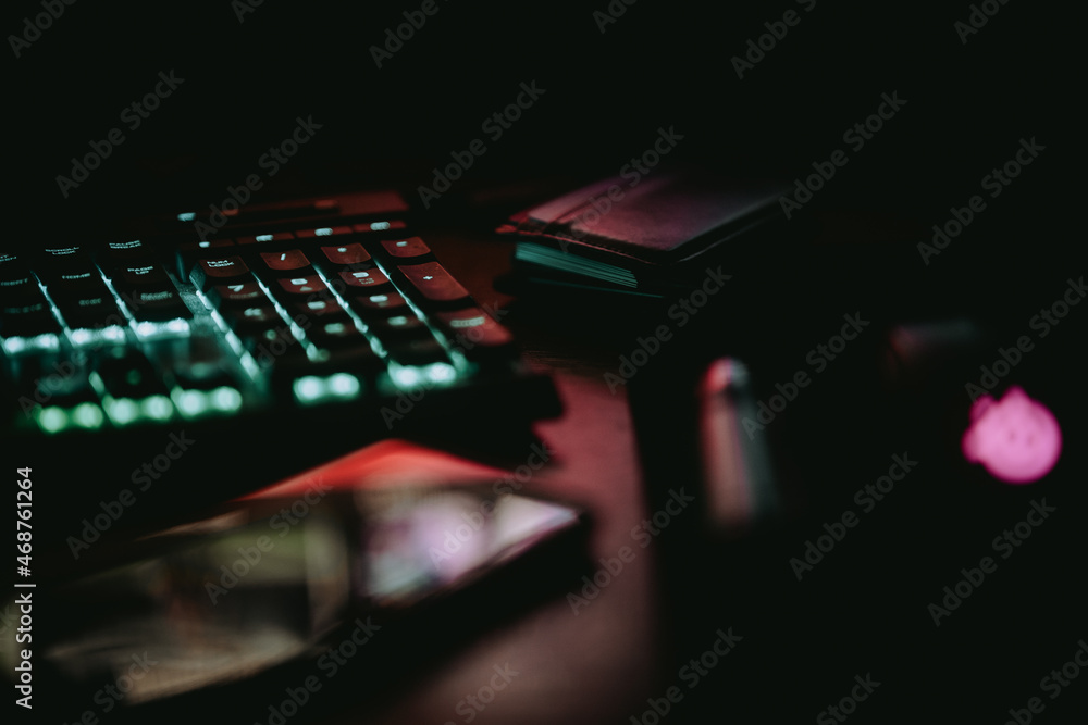 Poster closeup of a part of a glowing keyboard in the darkness.