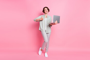Full length photo of cool bob hairdo lady hold laptop thumb up wear grey green cloth isolated on...