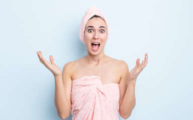 young pretty woman feeling happy and astonished at something unbelievable. beauty and shower concept