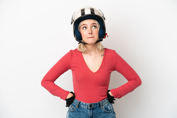 Young caucasian woman with a motorcycle helmet isolated on white background and looking up