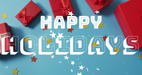 Image of happy holidays christmas text over presents on blue background