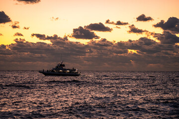 Fototapeta na wymiar Fishing boats on the ocean at Sunrise