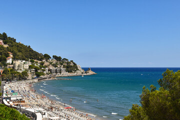 Panoramic view of the coastline with the promontory of Capo Santa Croce in a sunny summer day,...