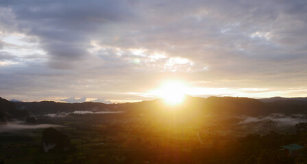 Fototapeta na wymiar Landscape sunrise over mountains and warm morning sun