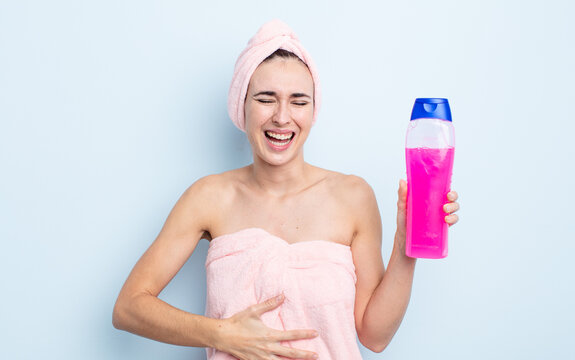 young pretty woman laughing out loud at some hilarious joke. shower and shapoo concept