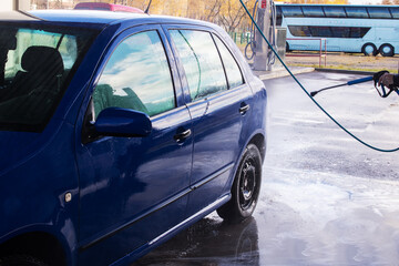 A man washing a car at a car wash