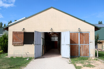 Fototapeta na wymiar Opened doors in rural animal barn on a sunny day