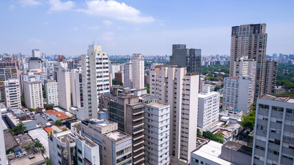 Obraz premium Aerial view of Jardins district in São Paulo, Brazil. Big residential and commercial buildings in a prime area near Av. Paulista with Ibirapuera Park on background. 