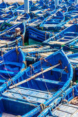 Fototapeta na wymiar Typical blue boats in the harbor of Essaouira, Morocco