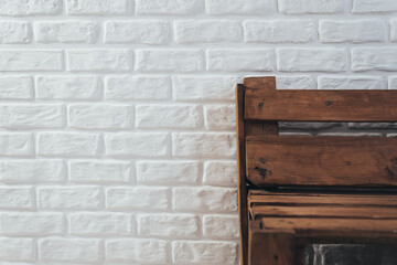 Wooden bench of flying against a white brick wall