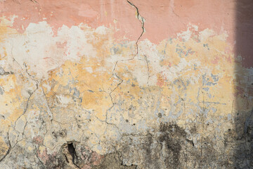 Old rough pink-orange plaster wall surface Artistic. Walls and background, yellow concrete surface