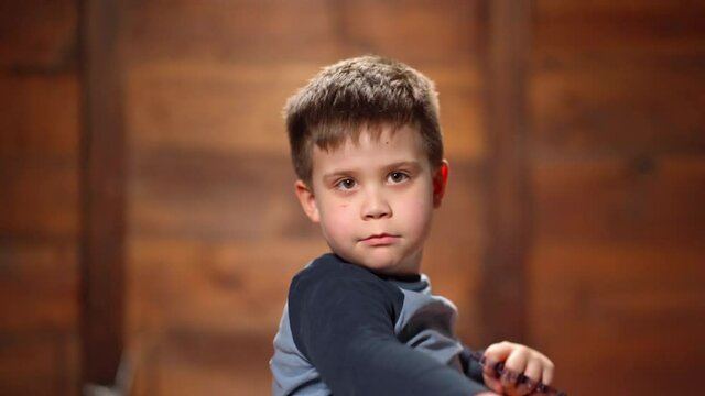 Angry Boy Waving Fists With Brass Knuckles. Violent Behavior With Physical Abuse.