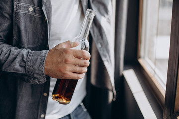 Man drinker depressed with bottle of whiskey