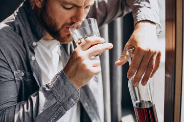 Man drinker depressed with bottle of whiskey
