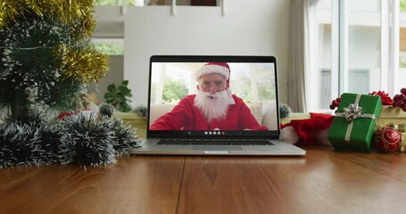 Caucasian man with santa costume on christmas video call on laptop - Powered by Adobe