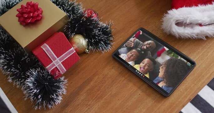 Smiling african american family on christmas video call on tablet