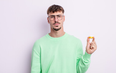 young handsome man feeling sad and whiney with an unhappy look and crying. contact lenses