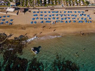 Top view on blue sun loungers on the beach