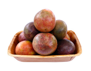 Passion fruit in a container made of natural materials place on a white background. Isolated.