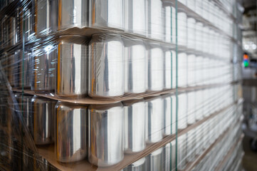 New beer cans stacked in warehouse. Empty aluminum can storage in brewery