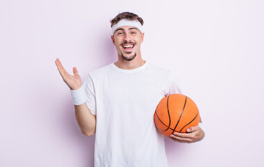 young handsome man feeling happy and astonished at something unbelievable. basketball concept