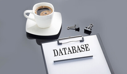 DATABASE text on paper sheet with coffee on the black background