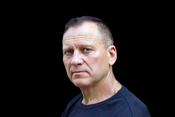 portrait of a handsome charming courageous middle-aged man, 50-55 years old, with a serious face, on an isolated black background