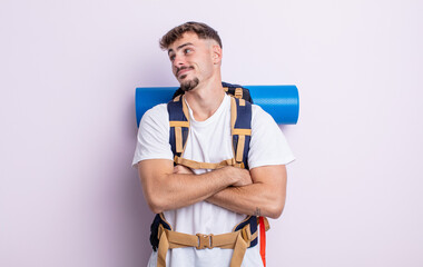 young handsome man shrugging, feeling confused and uncertain. hiker concept