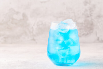 Refreshing blue drink or cocktail with ice