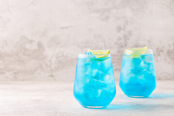 Refreshing blue drink or cocktail with ice