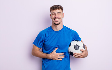 young handsome man laughing out loud at some hilarious joke. soccer concept