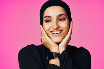 muslim woman with smart watch technology gadget pink background