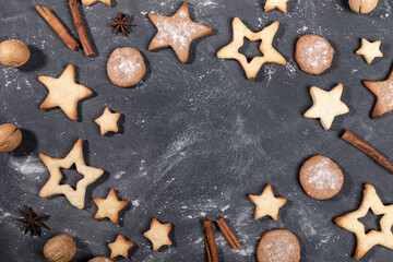 Obraz na płótnie Canvas Christmas mock up of homemade holiday cookies, cinnamon, walnuts, anise stars on black.