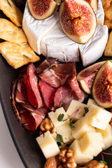 Assorted cheese, prosciutto, nuts, snacks and fruits