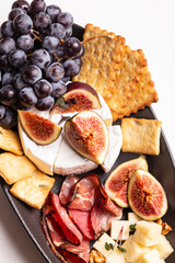 Assorted cheese, prosciutto, nuts, snacks and fruits