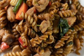 Spicy stir-fried macaroni with basil leaves