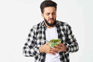 Cheerful man in plaid shirt plate with salad healthy food