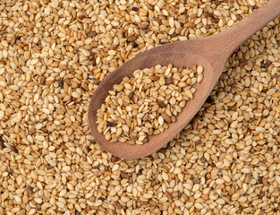 Closeup of sesame seeds on a wooden spoon
