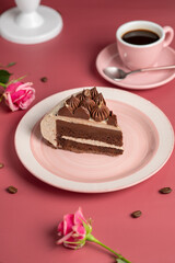 Coffee mousse cake with dark chocolate , sweet dessert over pink background. Piece of cake on a pink plate.