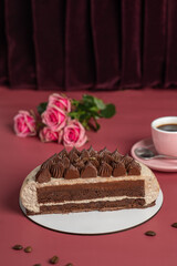 Coffee mousse cake with dark chocolate , sweet dessert over pink background. ?ake cut is chocolate sponge cake and coffee mousse.
