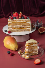 Biscuit cake covered with white cream cheese and garnished with berries. Cake homemade bakery.