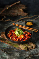 Vietnamese spicy caramel pork belly closeup on a plate on a table.