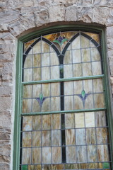 This is an ld window on a church, it seems like the glass has been replaced by wood.