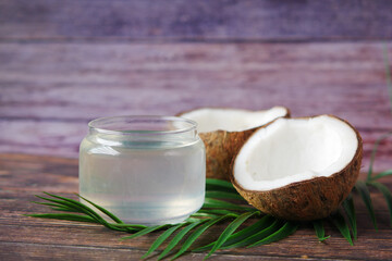 slice of fresh coconut and bottle of oil on a table 