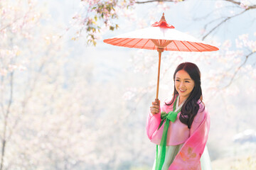 Young woman wearing hanbok Korean national costumes in famous tourist attractions in Seoul, South Korea