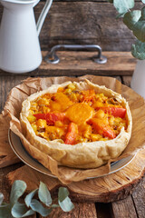 Pie with cheese, tomatoes and fish. Side view.