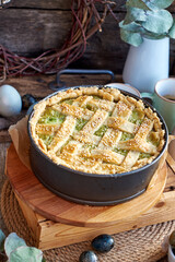 Easter pie with spinach, egg and cottage cheese. Wooden background, side view