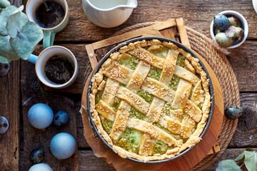 Easter pie with spinach, egg and cheese. Wooden background, top view