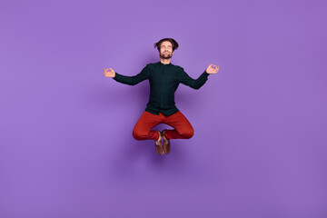 Fototapeta na wymiar Photo of attractive focused young man wear smart casual outfit smiling jumping practicing yoga isolated purple color background