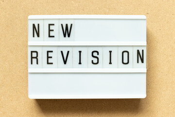 Lightbox with word new revision on wood background